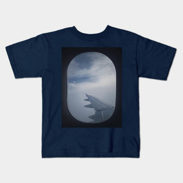 Plane flight through the dense clouds Kids T-Shirt by psychoshadow